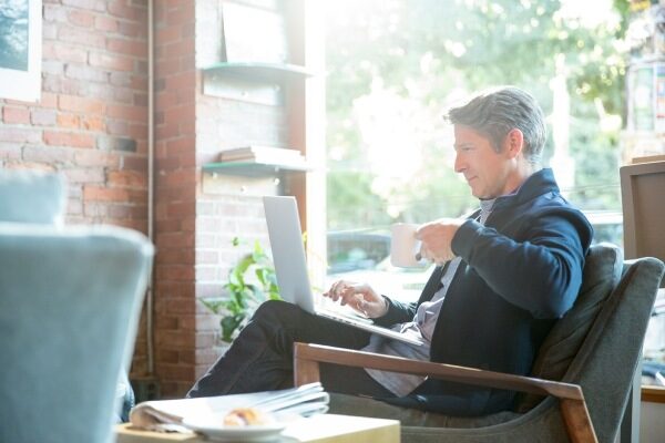 a man on a laptop in a coffee shop