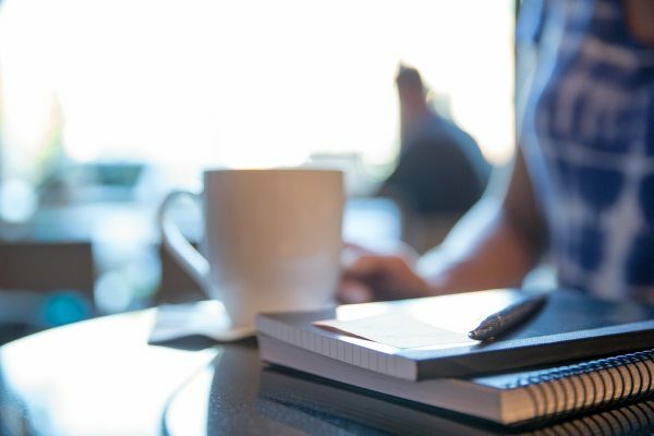 coffee cup and notebooks