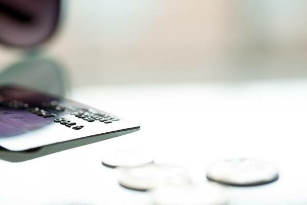 a credit card and change on a table