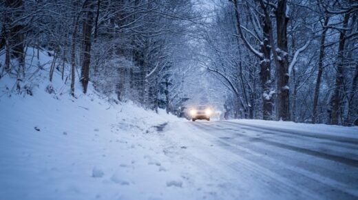 A car being driven in the snow.