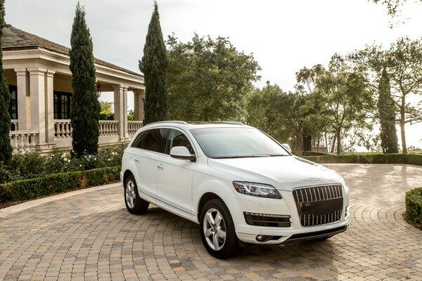 White luxury vehicle in front of home