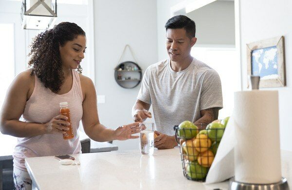 Couple Organizing Kitchen