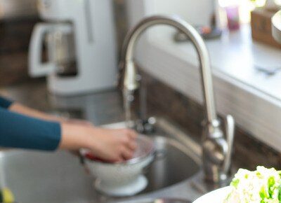 Hands Washing Lettuce In Sink