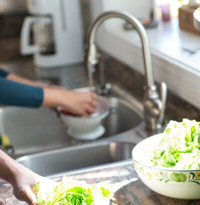 Hands Washing Lettuce In Sink