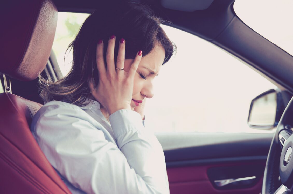 Stressed woman driver sitting inside her car