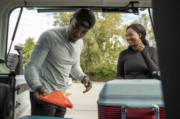 Man and Women looking into Trunk of Car