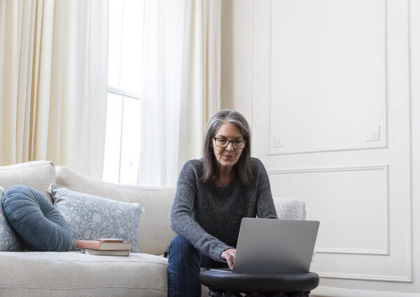 Woman Working on Laptop in Living Room