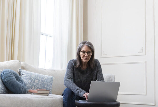 Woman Working on Laptop in Living Room