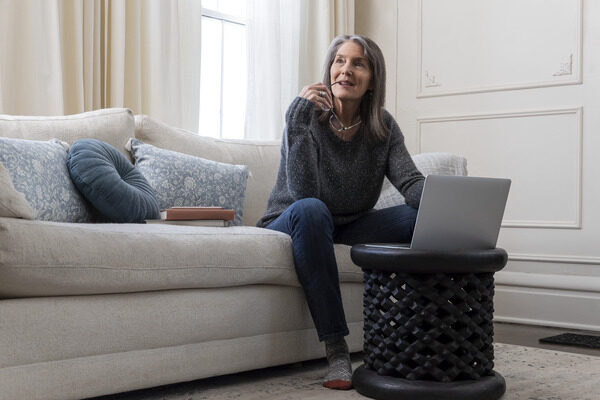 Woman Working on Laptop in Living Room