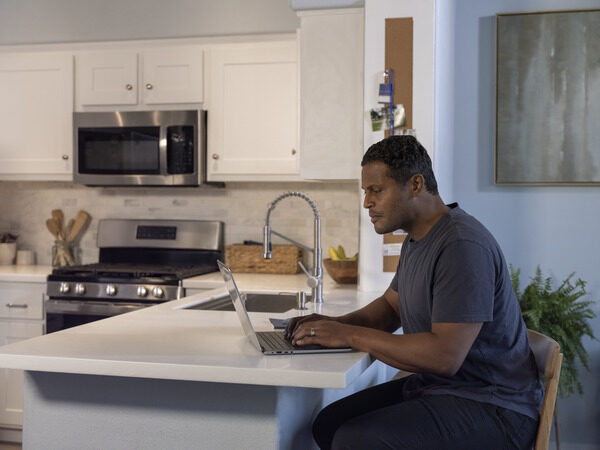 Man Typing at Countertop