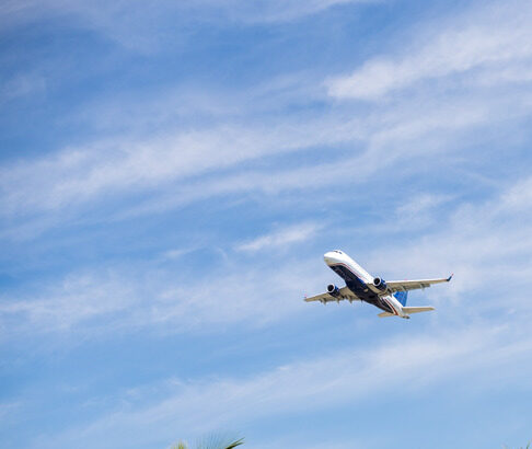 Plane Flying Above Tropical Landscape
