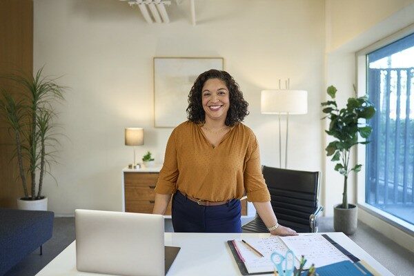 Woman Standing Behind Desk