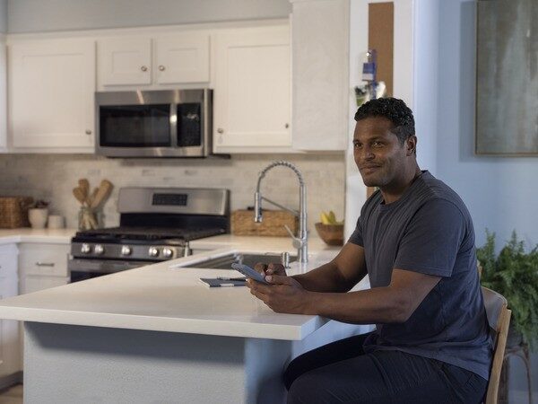 Man sitting next to microwave