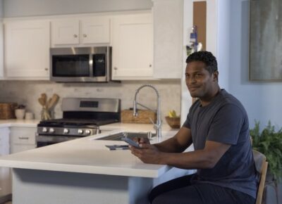 Man sitting next to microwave