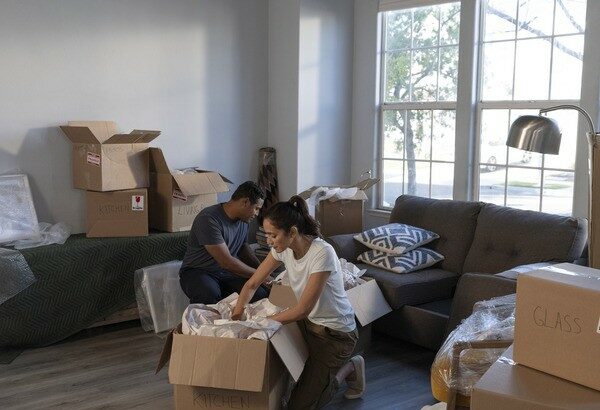 Couple packing in their living room