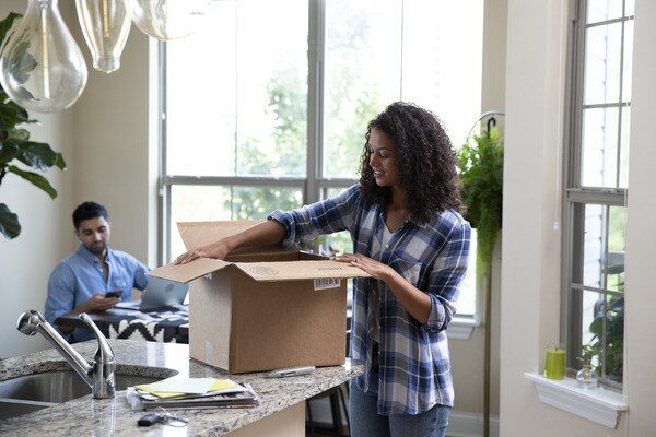 woman-unpacking-a-box-in-her-kitchen