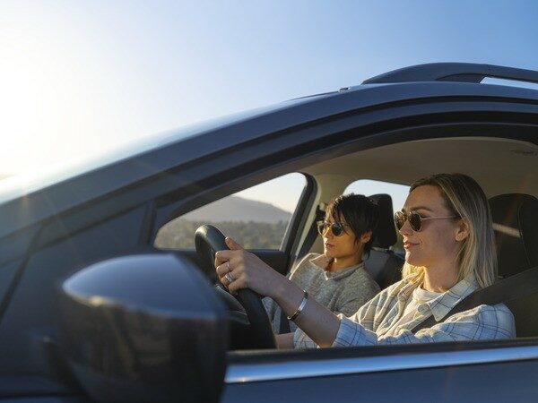 Woman driving in a car with a friend