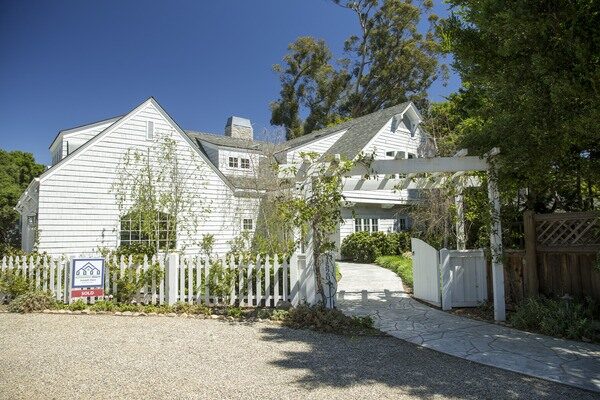 Exterior of a large white and gray home that is for sale