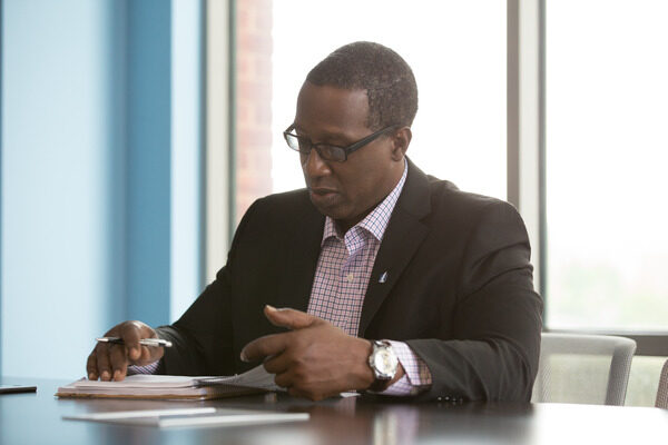 Man looking at paperwork on his desk