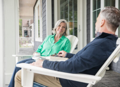 Two senior citizens discuss Medicare FAQs.