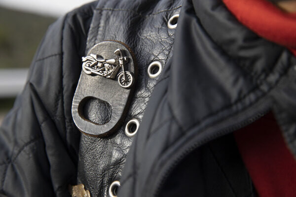 Closeup of a black leather jacket and motorcycle pin