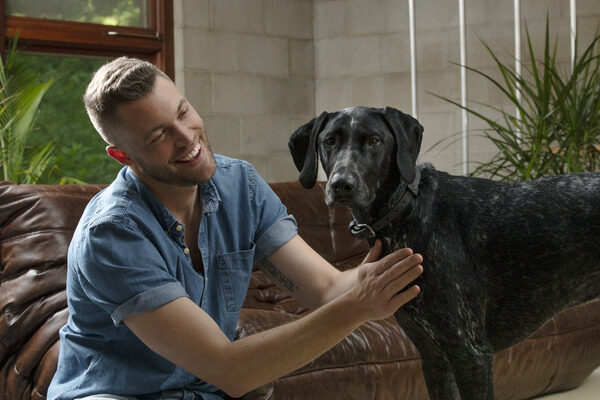 Man petting his dog