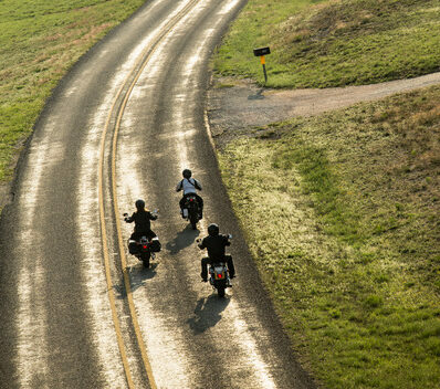 People riding on their motorcycles on an open road