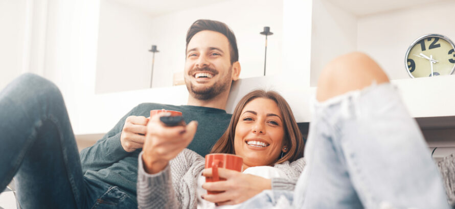 A couple relaxing while having some entertainment.