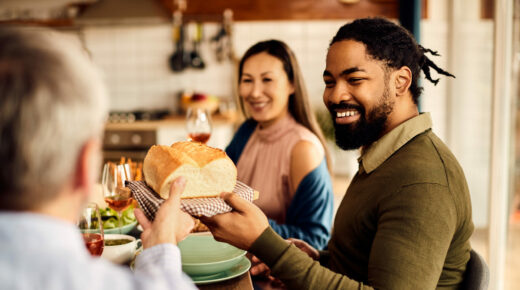 A happy family having a meal together at the table.