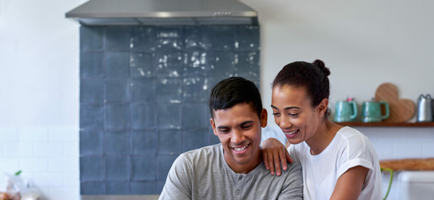 A couple checking out information on a tablet device.