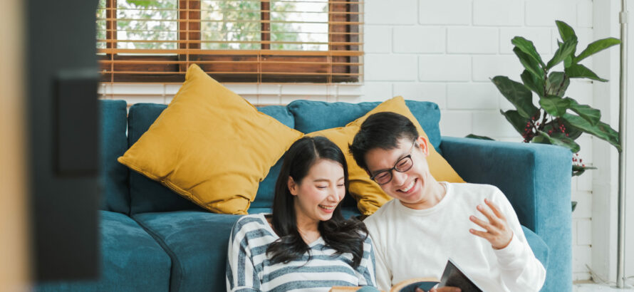 A happy couple browsing through catalogs together.