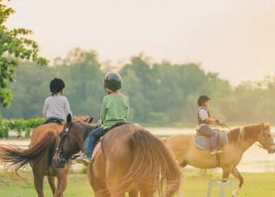 Three children riding horses.