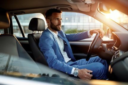 A man test driving a car.