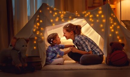 A mother and child in a tent.
