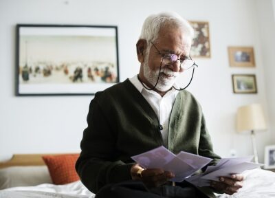 A man reads papers in his home.