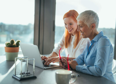 Two women looking at a laptop.