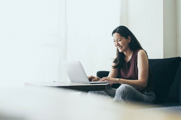 A woman using a laptop.