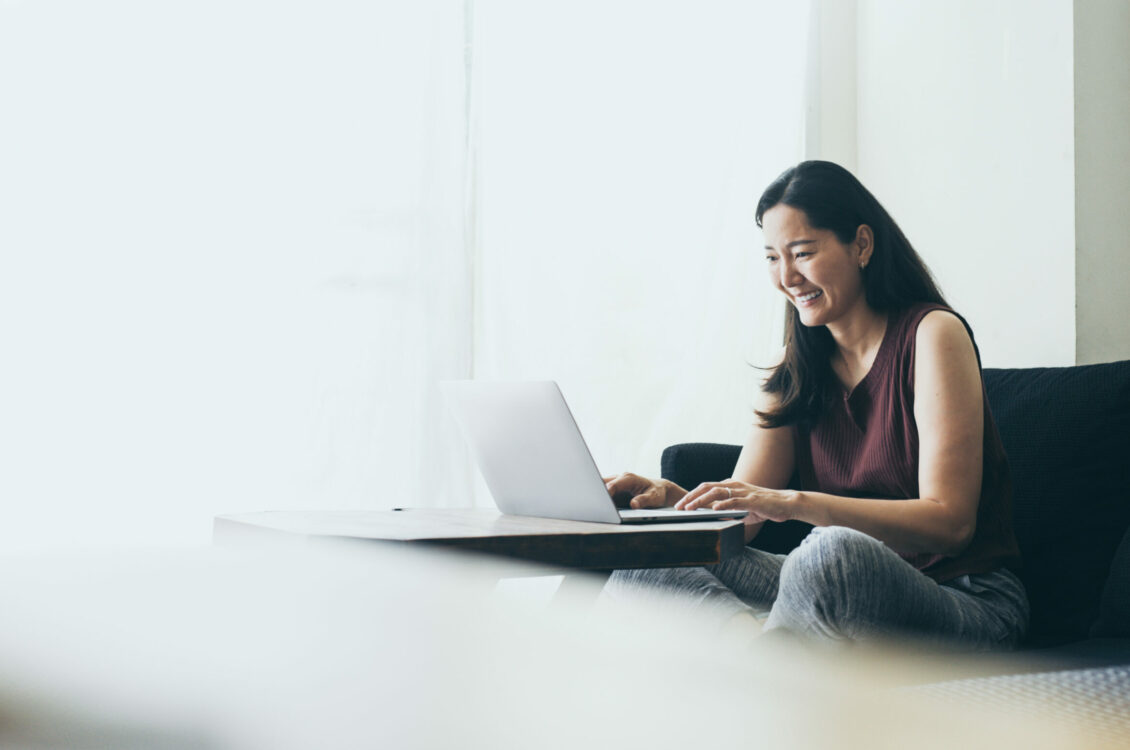 A woman works on a laptop.