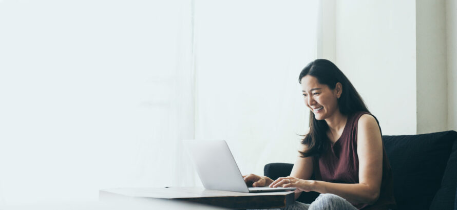 A woman works on a laptop.