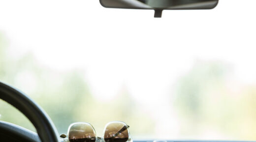 Sunglasses resting on the dashboard of a car.