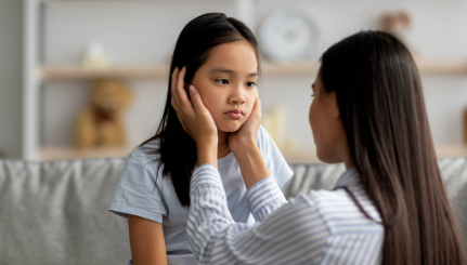 A sick child is comforted by a parent.