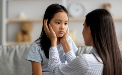 A sick child is comforted by a parent.