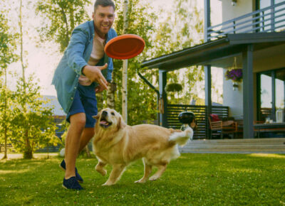 Man throws a frisbee to a dog.