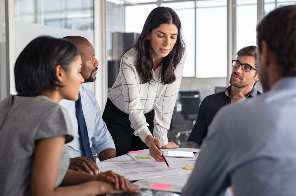 A group of people go over a business plan.