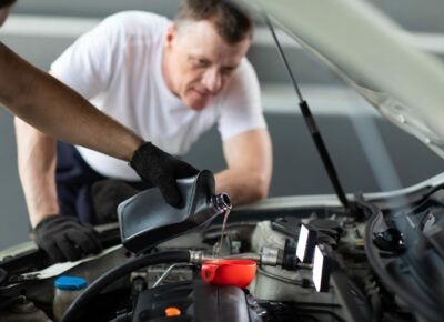 A man changing his car's oil.