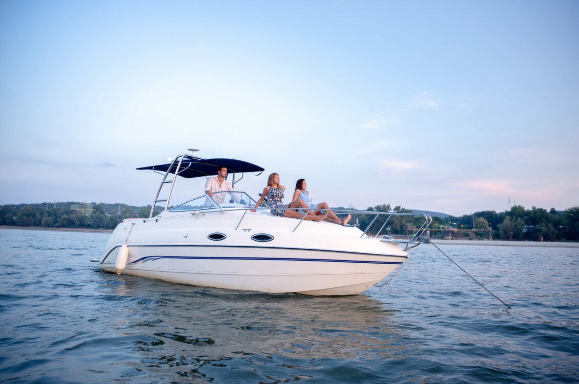 Three people enjoying recreational boating.