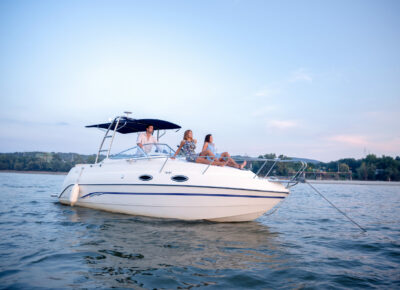 Three people enjoying recreational boating.