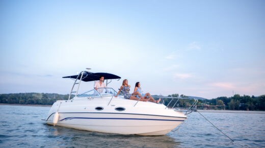Three people enjoying recreational boating.