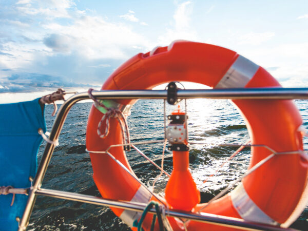 An orange life saver on the front of a boat.