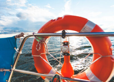 An orange life saver on the front of a boat.